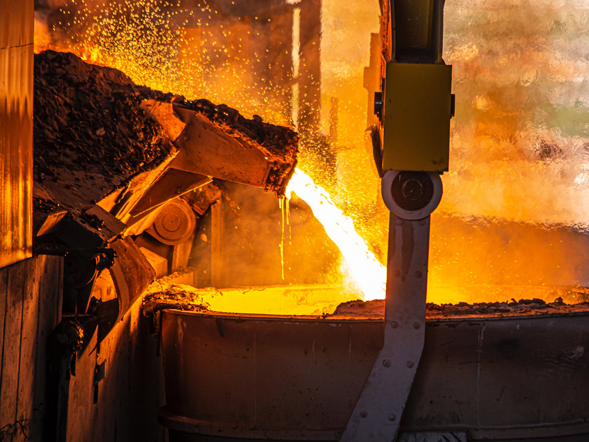 Glowing molten metal in an industrial foundry