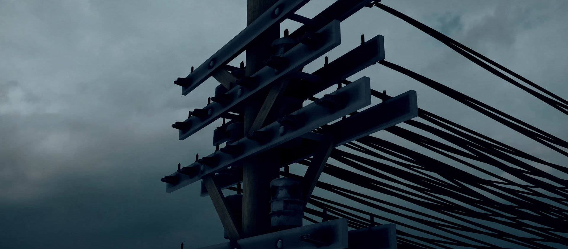 Utility pole carrying dozens of power lines against a stormy sky