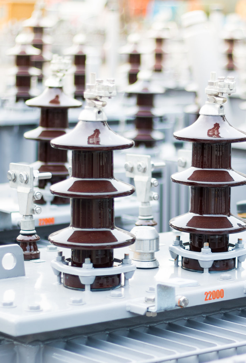 Rows of porcelain bushings on newly manufactured distribution transformers
