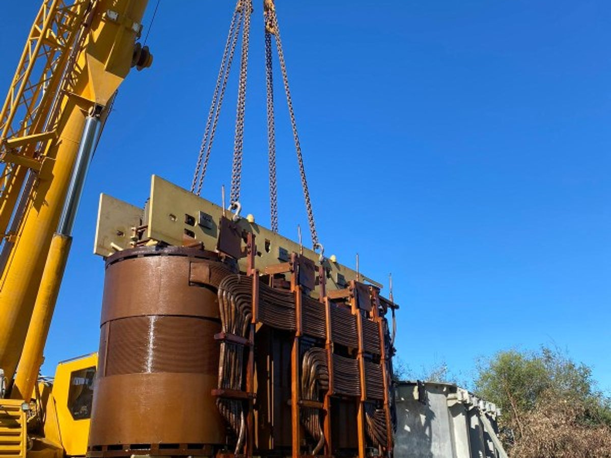 Crane lifting a transformer for on-site maintenance